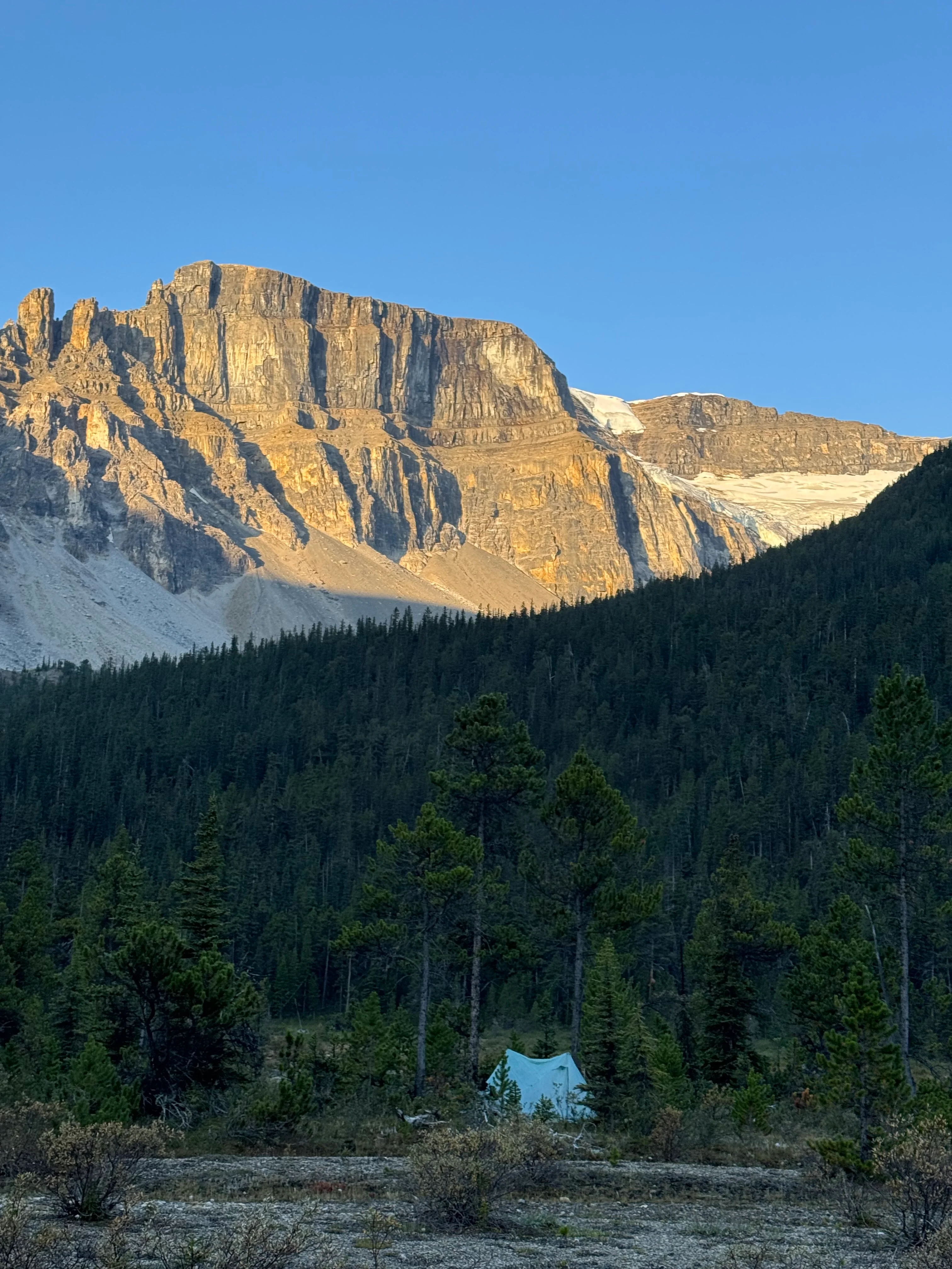 Tent pitched in tight spot between mountains